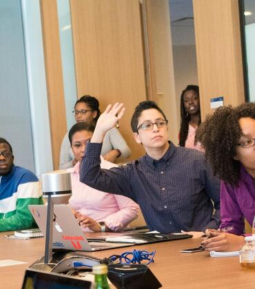 Group of professional at a meeting engaging in conversation 